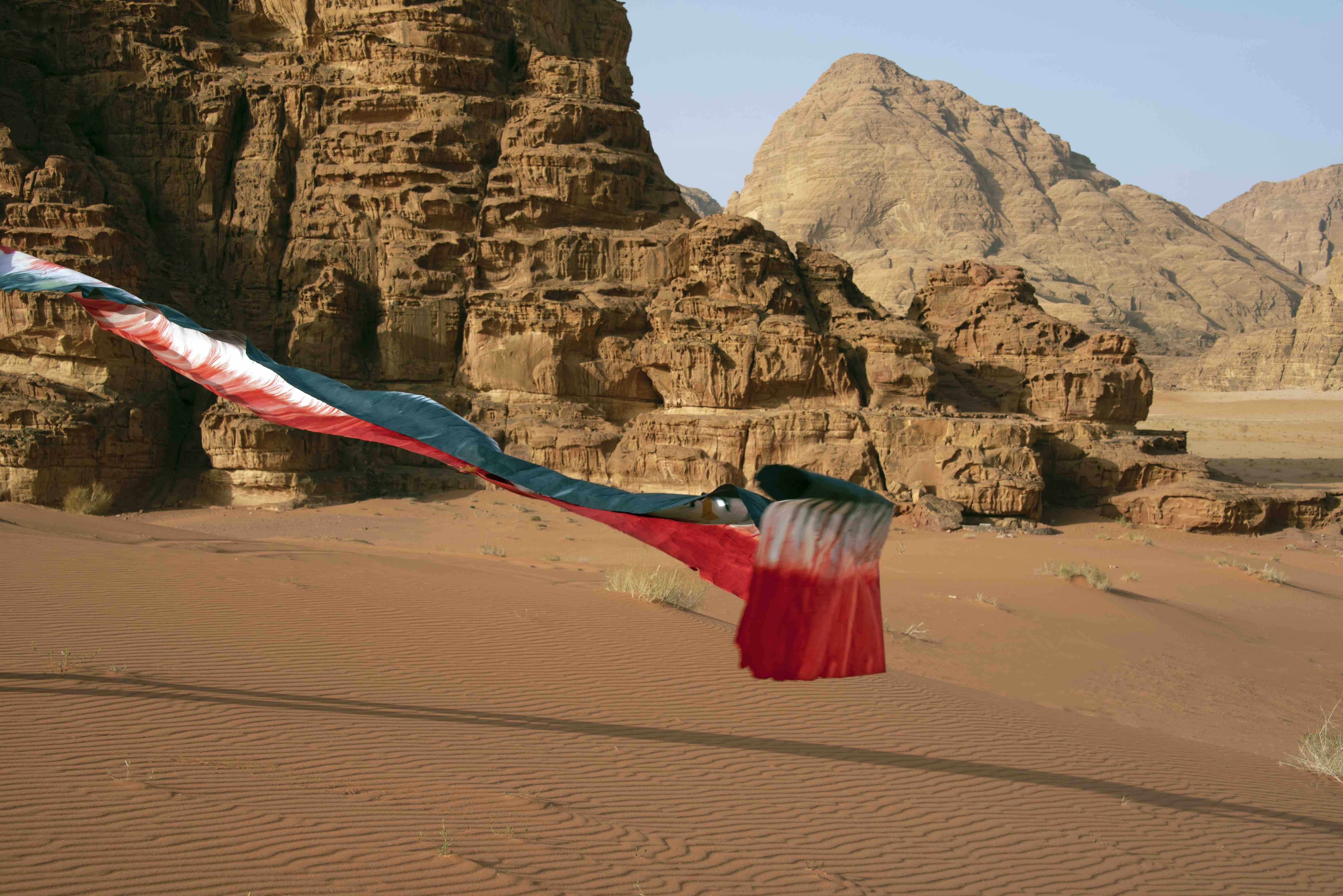 Units of Sediments and Materiality V, 2022 Performative intervention, Wadi Rum, Jordan Dyed mulberry fiber paper ribbon, 45 &times; 2500 cm Photograph, 50 &times; 70 cm Photo: Therese Weber